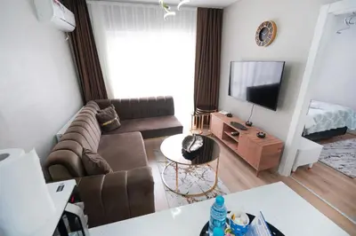 a living room with a couch and a television at Classic Suite TS32 in Esenyurt