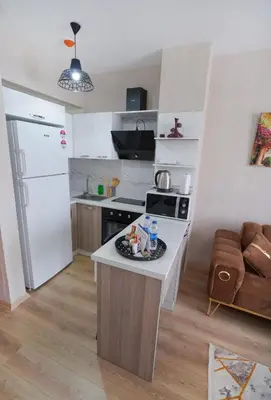 a kitchen with a white refrigerator and a counter top at Classic Suite TS22 in Esenyurt