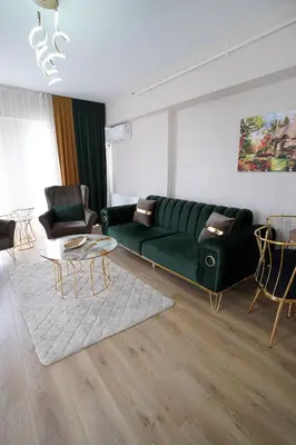 a living room with a green couch and a table at King Suite OJ9 in Esenyurt