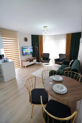 a living room with a table and chairs at King Suite OJ9 in Esenyurt