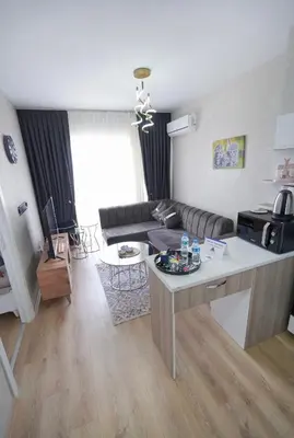 a living room with a couch and a table at Classic Suite TS23 in Esenyurt