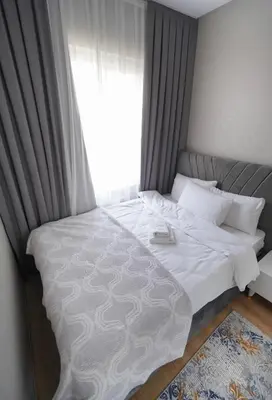 a bedroom with a large white bed with a window at Classic Suite TS23 in Esenyurt