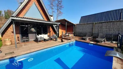 a house with a swimming pool next to a house at UĞURLUBUNGALOV in Sapanca