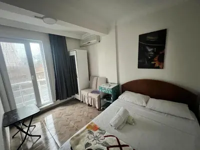 a bedroom with a bed and a large window at Airport See Viem Apartment in Arnavutköy