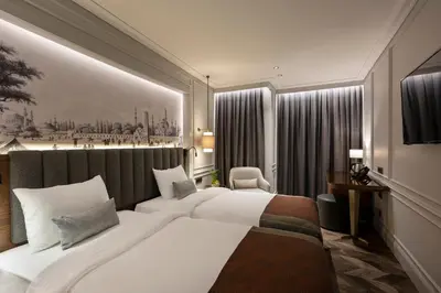 a hotel room with a large bed and a painting on the wall at Livro Hotel in Istanbul