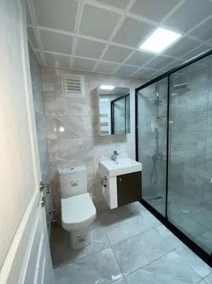 a bathroom with a toilet and a glass shower at Whole Apartment at The Heart of Sisli Nisantasi K in Istanbul