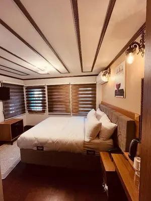 a bedroom with a large bed and a couch at PALMERA ART HOUSE in Istanbul