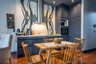 a kitchen with a wooden table and chairs at Benesta Guest Teori in Istanbul