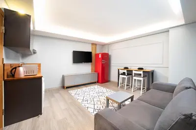 a living room with a couch and a red refrigerator at Park Çağlayan Hotel in Istanbul
