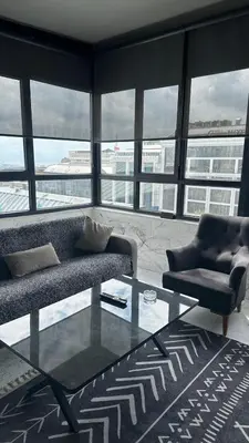 a living room with a couch and a glass table at Heraldic Room Hotel in Esenyurt