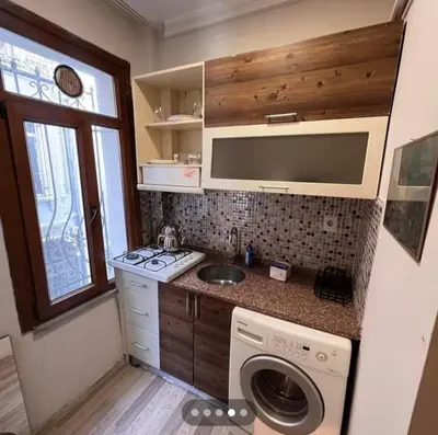 a kitchen with a sink and a washing machine at Easeinn in Istanbul