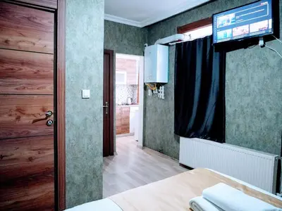 a room with a television and a bed in a room at Easeinn in Istanbul