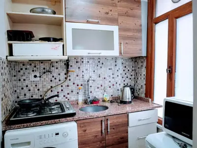 a small kitchen with a sink and a stove at Easeinn in Istanbul