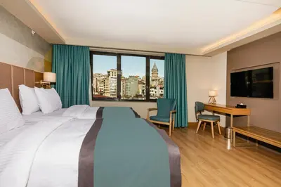 a hotel room with a large bed and a desk at Csk The Halich Port İstanbul in Istanbul