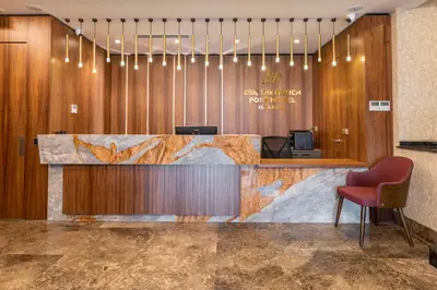 a lobby with a reception desk and a red chair at Csk The Halich Port İstanbul in Istanbul