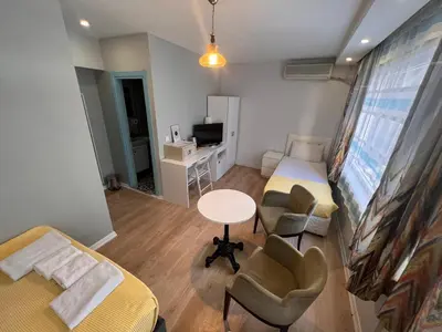 a small room with a bed and a table and chairs at Rodin Hostel in Istanbul