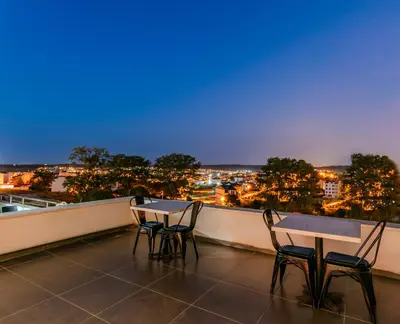 two tables and chairs on a balcony with a view at Intercity Hotel Istanbul Airport in Arnavutköy