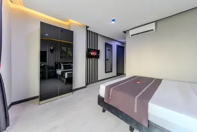 a bedroom with a bed and a living room at Intercity Hotel Istanbul Airport in Arnavutköy