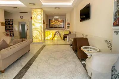 a salon with a waiting room with a couch and chairs at The Center Hotel in Istanbul