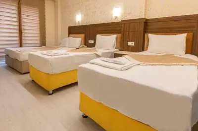 a room with three beds in a room at The Center Hotel in Istanbul
