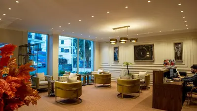 a lobby with a person sitting at a desk with a computer at My Palace Residance in İçmeler