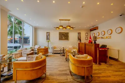 a lobby with couches and chairs in a building at My Palace Residance in İçmeler