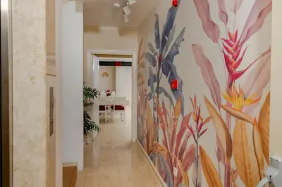 a hallway with a mural of flowers on the wall at My Palace Residance in İçmeler