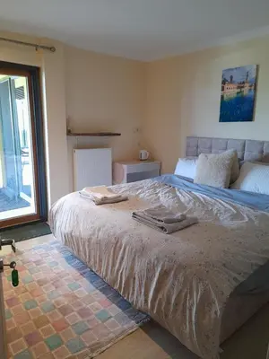 a large bed in a bedroom with a window at Turkish Mountain Retreat in Saadet