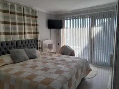 a bedroom with a bed and a chair and a window at Turkish Mountain Retreat in Saadet