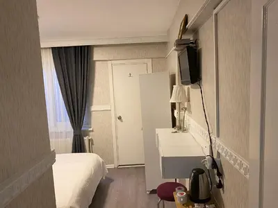 a hotel room with a bed and a television at antik sofia hotel in Istanbul