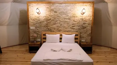 a bedroom with a bed with two pillows and a brick wall at Sapanca Green Dome in Sapanca