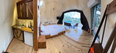 a bedroom with a bed and a table in a room at Sapanca Green Dome in Sapanca
