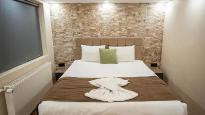 a hotel room with a bed with a robe on it at MİLA SUİTES TAKSİM in Istanbul