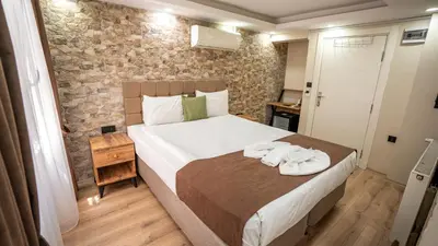 a bedroom with a bed with towels on it at MİLA SUİTES TAKSİM in Istanbul