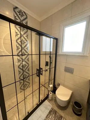 a bathroom with a toilet and a window at Center of city in Beşiktaş 2 plus 1 with 2 Bathroom and 3 Air Conditioner in Istanbul