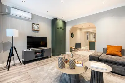 a living room with a couch and a tv at sevim suites Nişantaşı in Istanbul