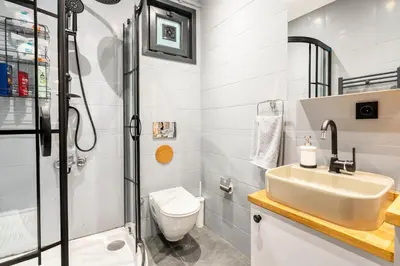 a bathroom with a shower and a sink and a toilet at sevim suites Nişantaşı in Istanbul
