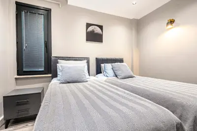 a bedroom with two beds and a window at sevim suites Nişantaşı in Istanbul