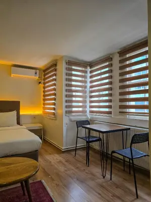 a bedroom with a bed and a table and chairs at Karakoy Port House in Istanbul