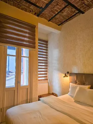 a bedroom with a large bed and a window at Karakoy Port House in Istanbul