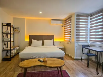 a bedroom with a bed with a table and a coffee table at Karakoy Port House in Istanbul