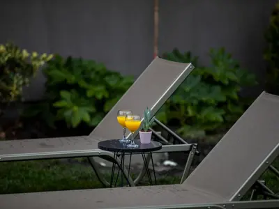 a glass of orange juice on a table on a chair at New Balturk Villas Sapanca in Sapanca