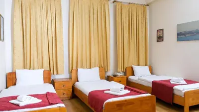 a room with two beds with towels on them at Istanbul Irish Hotel in Istanbul