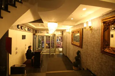 a man sitting at a table in a hallway at ZEO HOTEL merter in Istanbul