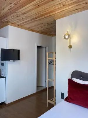 a bedroom with a bed and a tv on a wall at PANORAMA CITY SUITE in Istanbul