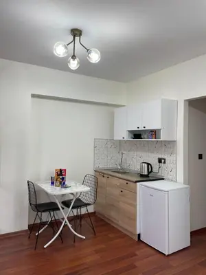 a kitchen with a table and chairs in a room at PANORAMA CITY SUITE in Istanbul