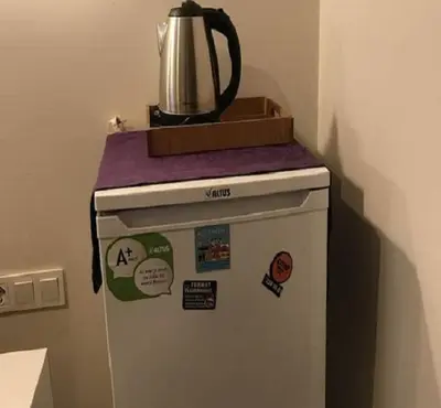a small refrigerator with a kettle on top of it at Taksim Soushian Hotel in Istanbul