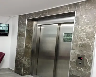 a shower in a bathroom with a stone wall at Taksim Soushian Hotel in Istanbul