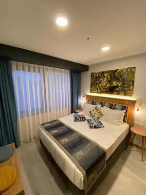 a bedroom with a large bed and a large window at The Gate Kadıköy Downtown in Istanbul