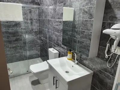 a bathroom with a white sink and a toilet at ÖZTÜRKS HOTEL in Istanbul
